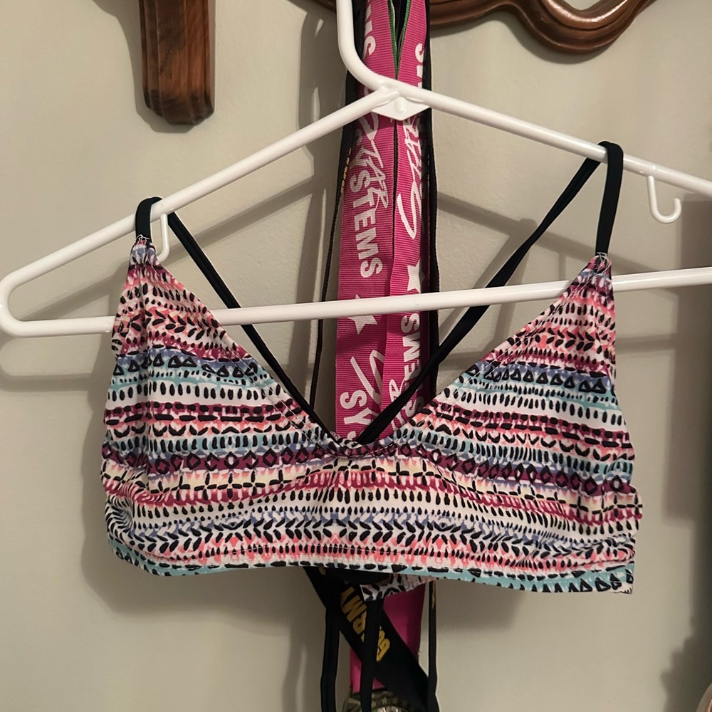 This is a pink printed bikini top by the brand SO in a size small.